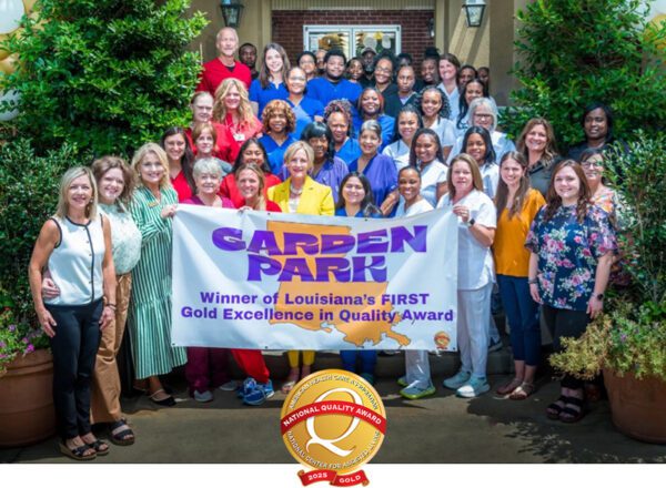 group of Garden Park staff holing banner announcing award